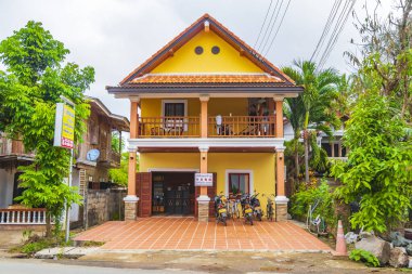 Luang Prabang Laos 16 numara. Kasım 2018 Luang Prabang Laos 'ta bir caddede tipik sarı ev yapımı otel..