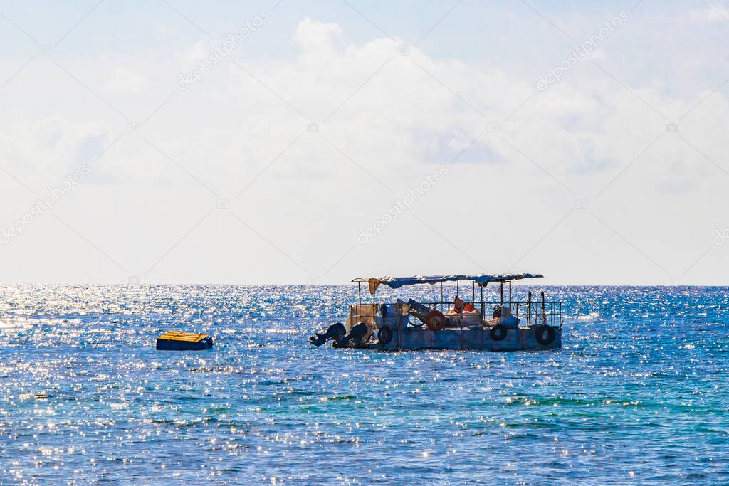Fishing boats at tropical mexican beach panorama view with turquoise blue water from Playa 88 and Punta Esmeralda in Playa del Carmen Mexico.
