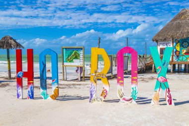 Holbox Mexico 21. December 2021 Colorful welcome letters and sign on the beautiful Holbox island sandbank and beach with waves turquoise water and blue sky in Quintana Roo Mexico.