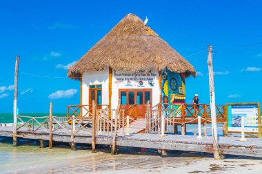 Holbox Mexico 21. December 2021 Panorama landscape view on beautiful Muelle principal de Holbox jetty and hut on Holbox island and beach with waves turquoise water and blue sky in Quintana Roo Mexico.