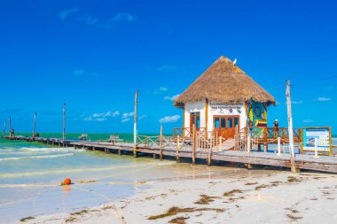 Holbox Mexico 21. December 2021 Panorama landscape view on beautiful Muelle principal de Holbox jetty and hut on Holbox island and beach with waves turquoise water and blue sky in Quintana Roo Mexico.