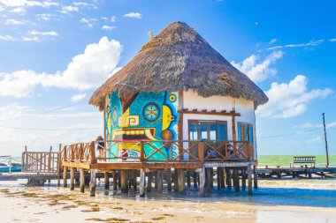 Holbox Mexico 21. December 2021 Panorama landscape view on beautiful Muelle principal de Holbox jetty and hut on Holbox island and beach with waves turquoise water and blue sky in Quintana Roo Mexico.