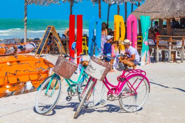 Holbox Mexico 21. December 2021 Colorful welcome letters and sign on the beautiful Holbox island sandbank and beach with waves turquoise water and blue sky in Quintana Roo Mexico. clipart