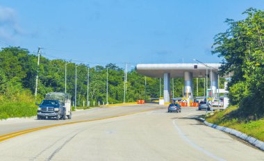 Driving on the highway thru the Caseta de Cobro toll booth house of Quintana Roo and Lazaro Cardenas Mexico.