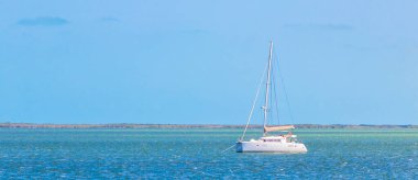 Panorama landscape view on beautiful Holbox island with luxury travel on boats yachts on turquoise water in Quintana Roo Mexico.