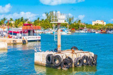 Holbox Mexico 21. December 2021 Panorama landscape view on Holbox island with boats Holbox Express ferry village port harbor Muelle de Holbox seagulls pelicans birds and turquoise water in Mexico.
