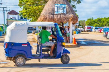 Chiquil Mexico 21. December 2021 Blue auto rickshaw tuk tuk in beautiful Chiquila village port harbor Puerto de Chiquil in Quintana Roo Mexico. clipart