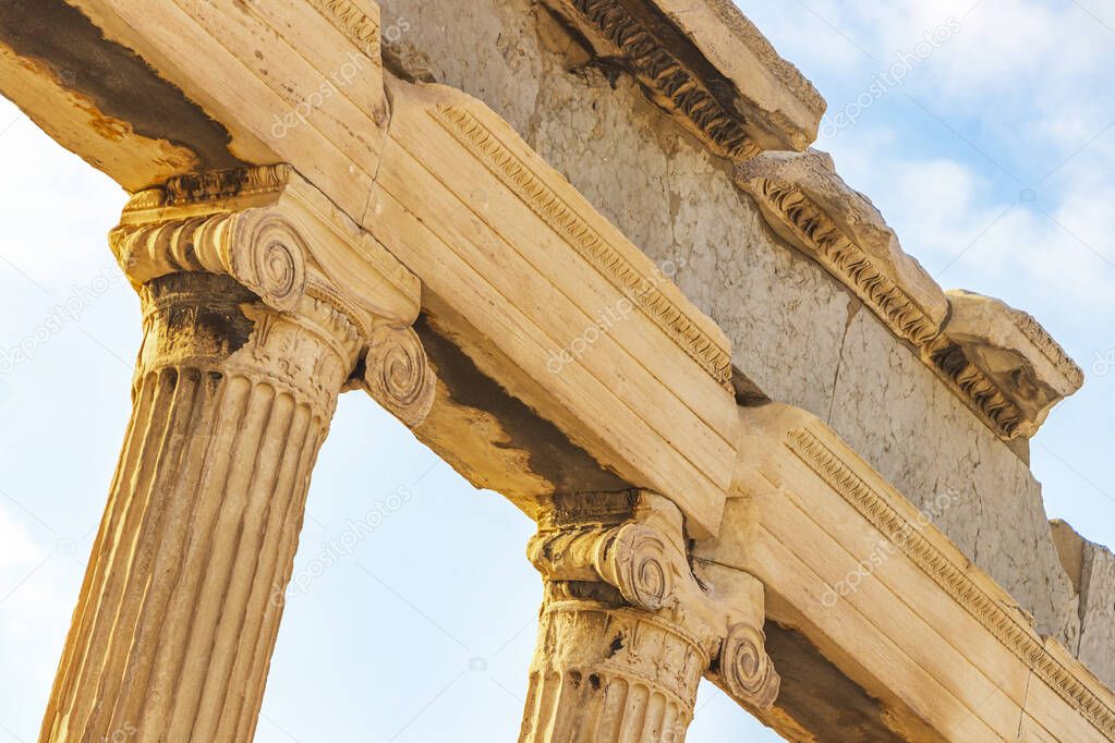 Details figures sculptures columns of the Acropolis of Athens with amazing and beautiful ruins Parthenon and blue cloudy sky in Greece's capital Athens in Greece.