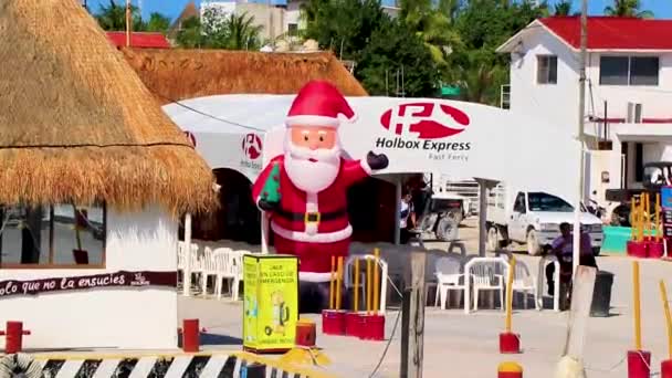 Holbox Mexico 21. December 2021 Merry Christmas X-Mas Santa Clause welcomes you to the beautiful Holbox island and village port harbor Muelle de Holbox in Quintana Roo Mexico.