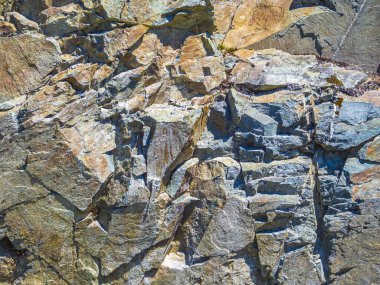 Hemsedal Norveç 'te turuncu ve sarı yosun ve liken renkleriyle taş duvar dokusu.