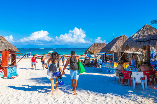 Tulum Mexico 02. February 2022 Amazing and beautiful caribbean coast and beach panorama view with turquoise water people huts and boats of Tulum in Quintana Roo Mexico.