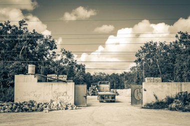 Tulum Mexico 02. February 2022 Old black and white picture of trucks dump truck and other industrial vehicles on typical street road and cityscape in Tulum in Mexico.