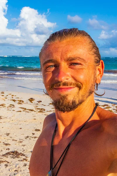 Mutlu model turist ve gezgin, Quintana Roo Mexico 'daki Turkuaz su insanları ve Tulum kulübeleriyle Karayip sahilleri ve sahil manzarasına gülümsüyor..