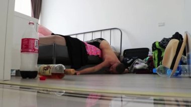 Wake up hungover with headache in the morning in apartment in Bangkok Thailand Asia.