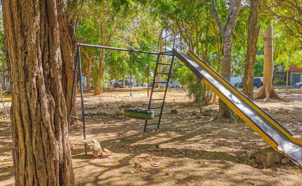 Slide and climbing frame on a playground in a park in Playa del Carmen Quintana Roo Mexico.