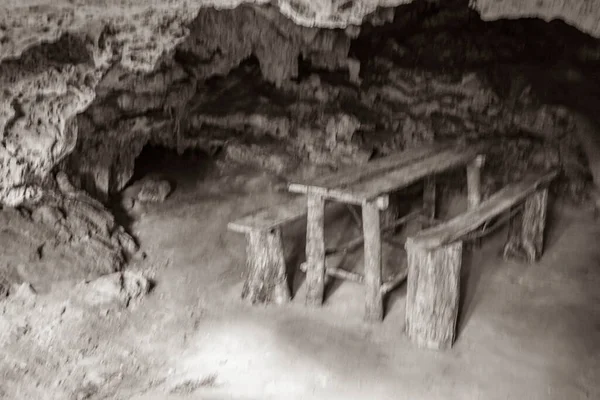 Old black and white picture of Amazing blue turquoise water and limestone cave sinkhole cenote at Santuario de los guerreros in Puerto Aventuras Quintana Roo Mexico.