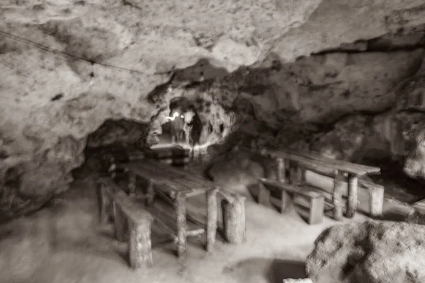 Old black and white picture of Amazing blue turquoise water and limestone cave sinkhole cenote at Santuario de los guerreros in Puerto Aventuras Quintana Roo Mexico.