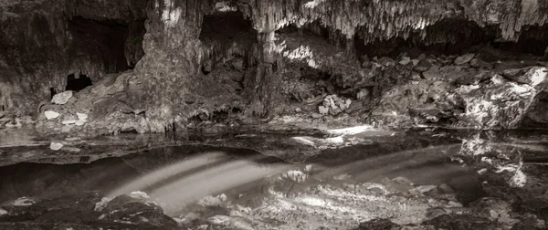 Old black and white picture of Amazing blue turquoise water and limestone cave sinkhole cenote Tajma ha Tajmaha in Puerto Aventuras Quintana Roo Mexico.
