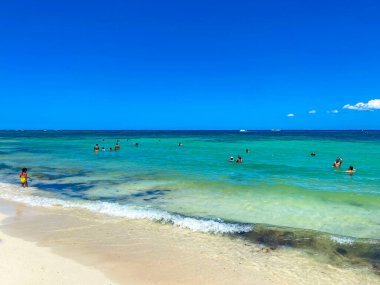 Playa del Carmen 14. May 2022 Tropical mexican beach landscape panorama full of people at beach parties on vacation in Playa del Carmen Mexico.