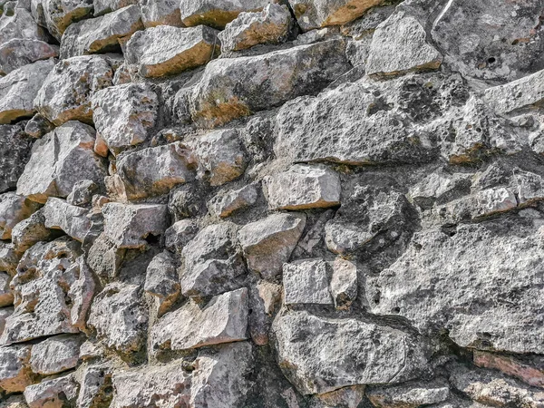 Texture and pattern of the ancient Tulum ruins Mayan site with temple ruins pyramids and artifacts in the tropical natural jungle forest palm and seascape panorama view in Tulum Mexico.