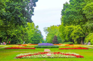 Natural beautiful panorama view with pathway colorful flowers and green plants trees in the forest of Buergerpark in Geestemnde Bremerhaven Germany.