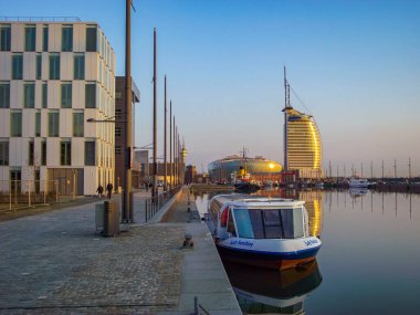 Bremerhaven Germany 12. March 2011 Sunset and cityscape and coast panorama of ATLANTIC Hotel Sail City lighthouse architecture ships yachts boats dike and landscape of Bremerhaven in Germany.