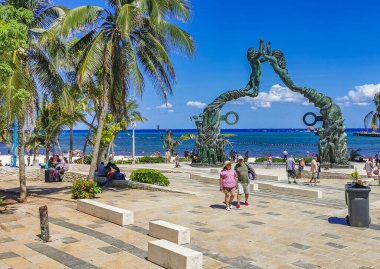 Playa del Carmen Mexico 14. May 2022 The ancient architecture of the Portal Maya in the Fundadores park with blue sky and turquoise seascape and beach panorama in Playa del Carmen Quintana Roo Mexico.