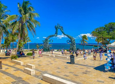 Playa del Carmen Mexico 14. May 2022 The ancient architecture of the Portal Maya in the Fundadores park with blue sky and turquoise seascape and beach panorama in Playa del Carmen Quintana Roo Mexico.