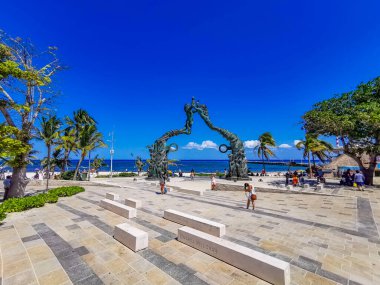 Playa del Carmen Mexico 14. May 2022 The ancient architecture of the Portal Maya in the Fundadores park with blue sky and turquoise seascape and beach panorama in Playa del Carmen Quintana Roo Mexico.
