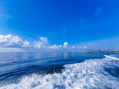 Boat trip tour from Cancun to Island Mujeres Isla Contoy and Whale shark tour with natural tropical seascape panorama and blue turquoise and green clear water view from boat in Quintana Roo Mexico.