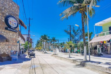 Holbox Mexico 16. May 2022 Colorful village on beautiful Holbox island with restaurant store vehicles people and mud in Quintana Roo Mexico.