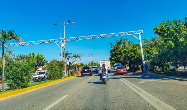 Cancun Mexico 13. January 2022 Typical street road and cityscape with cars and buildings of Cancun in Quintana Roo Mexico.