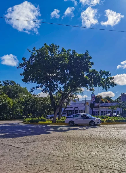 Cancun Mexico 13. January 2022 Typical street road and cityscape with cars and buildings of Cancun in Quintana Roo Mexico.