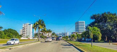 Cancun Mexico 13. January 2022 Typical street road and cityscape with cars and buildings of Cancun in Quintana Roo Mexico.