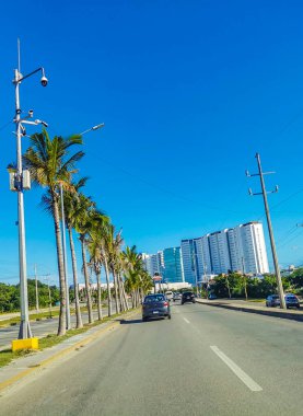 Cancun Mexico 13. January 2022 Typical street road and cityscape with cars and buildings of Cancun in Quintana Roo Mexico.