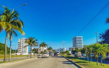 Cancun Mexico 13. January 2022 Typical street road and cityscape with cars and buildings of Cancun in Quintana Roo Mexico.