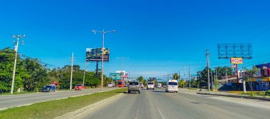 Cancun Mexico 13. January 2022 Typical street road and cityscape with cars and buildings of Cancun in Quintana Roo Mexico.