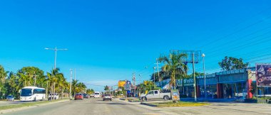 Cancun Mexico 13. January 2022 Typical street road and cityscape with cars and buildings of Cancun in Quintana Roo Mexico.