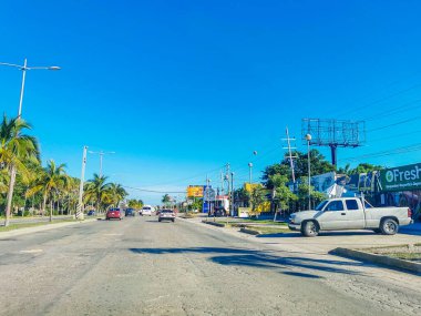 Cancun Mexico 13. January 2022 Typical street road and cityscape with cars and buildings of Cancun in Quintana Roo Mexico.