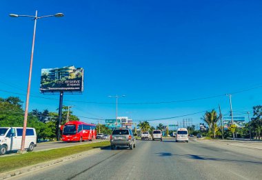 Cancun Mexico 13. January 2022 Typical street road and cityscape with cars and buildings of Cancun in Quintana Roo Mexico.