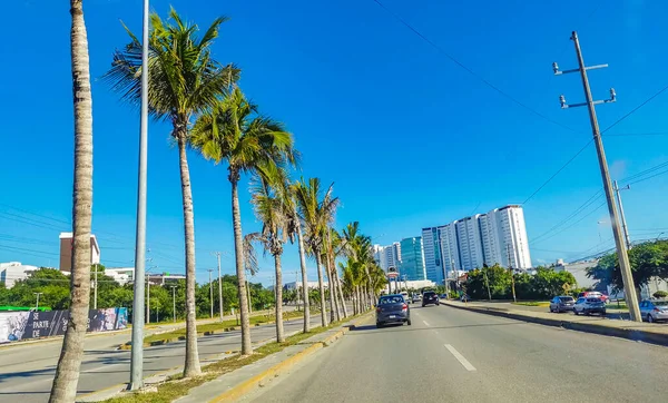 Cancun Mexico 13. January 2022 Typical street road and cityscape with cars and buildings of Cancun in Quintana Roo Mexico.