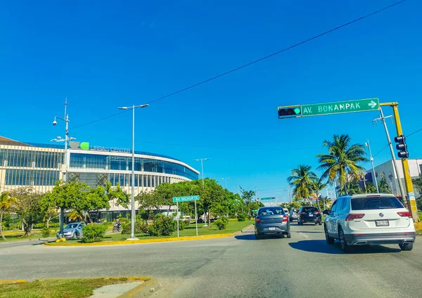 Cancun Mexico 13. January 2022 Typical street road and cityscape with cars and buildings of Cancun in Quintana Roo Mexico.