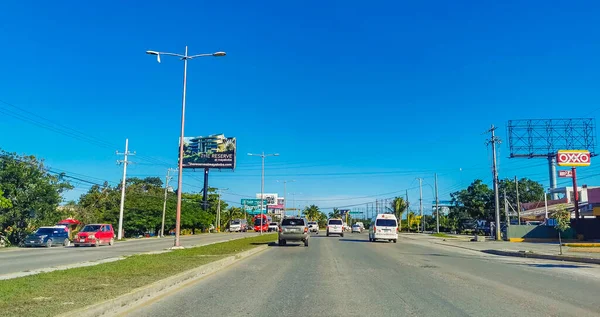 Cancun Mexico 13. January 2022 Typical street road and cityscape with cars and buildings of Cancun in Quintana Roo Mexico.