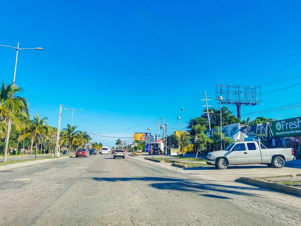 Cancun Mexico 13. January 2022 Typical street road and cityscape with cars and buildings of Cancun in Quintana Roo Mexico.