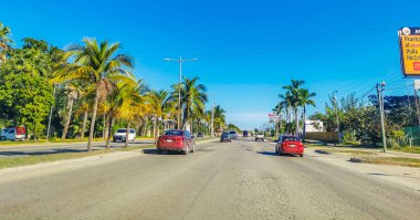 Cancun Mexico 13. January 2022 Typical street road and cityscape with cars and buildings of Cancun in Quintana Roo Mexico.