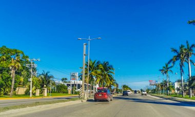 Cancun Mexico 13. January 2022 Typical street road and cityscape with cars and buildings of Cancun in Quintana Roo Mexico.