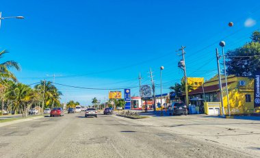 Cancun Mexico 13. January 2022 Typical street road and cityscape with cars and buildings of Cancun in Quintana Roo Mexico.