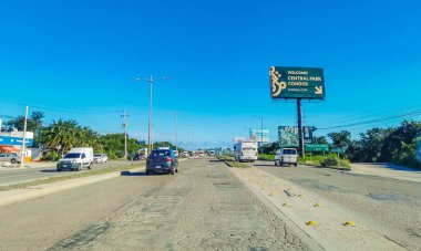 Cancun Mexico 13. January 2022 Typical street road and cityscape with cars and buildings of Cancun in Quintana Roo Mexico.