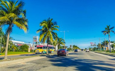 Cancun Mexico 13. January 2022 Typical street road and cityscape with cars and buildings of Cancun in Quintana Roo Mexico.