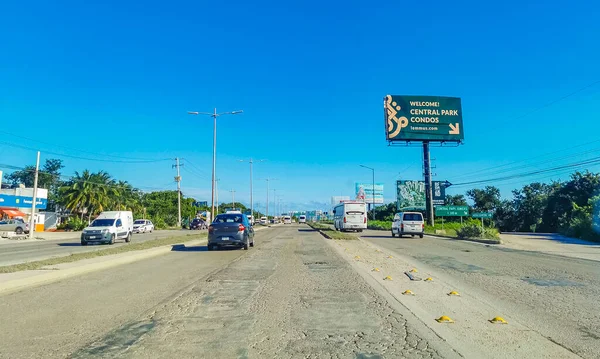 Cancun Mexico 13. January 2022 Typical street road and cityscape with cars and buildings of Cancun in Quintana Roo Mexico.